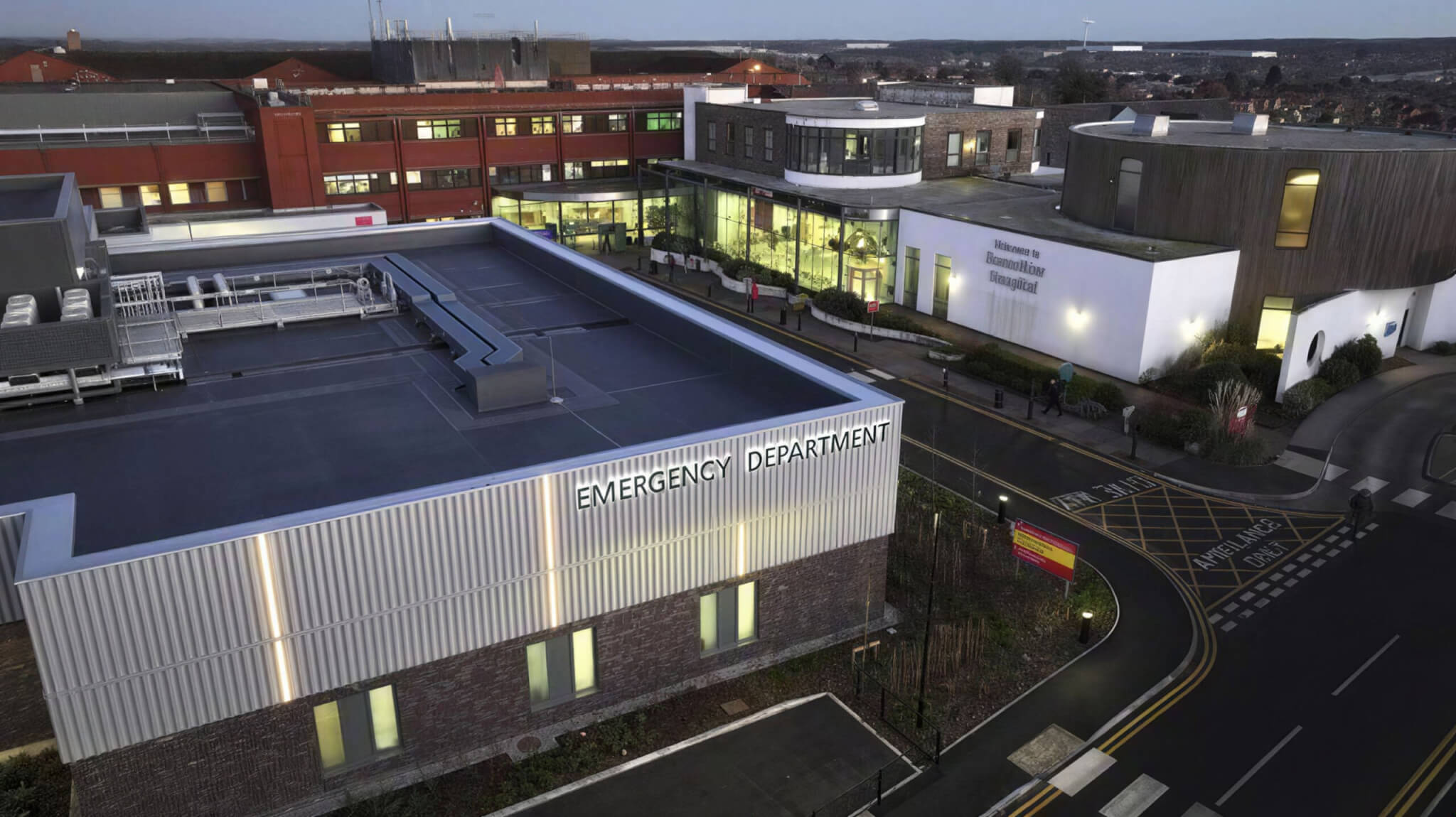 Bassetlaw Hospital Emergency Department at dusk, showing the completed new-build extension integrated into the live hospital site