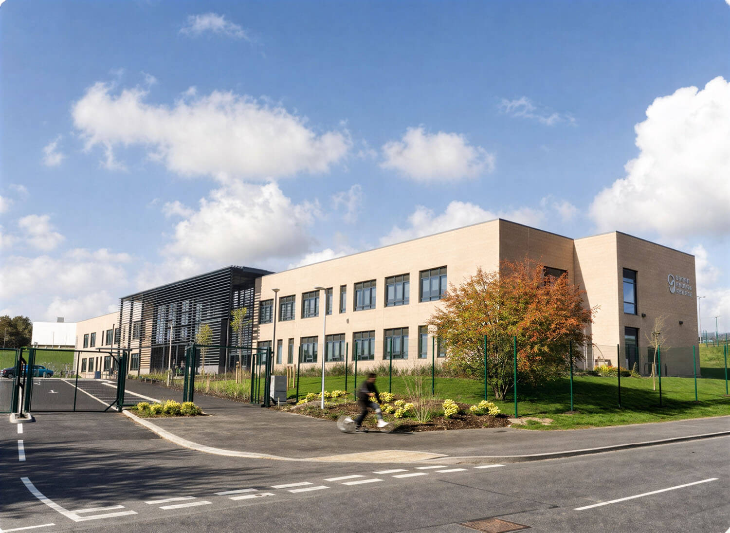 Two-storey brick exterior of Pudsey Sixth Form College with brise soleil shading the main entrance.